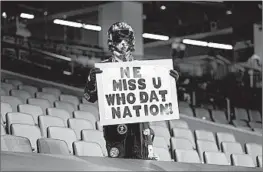  ??  ?? A fan holds a sign during a New Orleans Saints home game on Oct. 25.