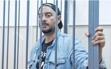  ??  ?? Serebrenni­kov, charged with fraud, looks out from a defendants’ cage during a hearing at Moscow’s Basmanny district court on Wednesday. — AFP photo