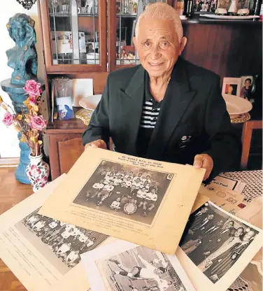  ?? Picture: WERNER HILLS ?? SPECIAL LEGACY: St Marks Rugby Football club veteran Harold Wilson shows off some old photograph­s as the club prepares to celebrate its centenary with a banquet later this month