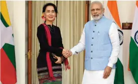  ??  ?? NEW DELHI: Indian Prime Minister Narendra Modi (R) shakes hand with Myanmar State Counsellor Aung San Suu Kyi before a meeting. — AFP