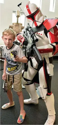  ?? Farmer Photos: Kevin ?? READY FOR ACTION: Young Ethan Hough with ARC stormtroop­er Luke Shadbolt at Star Wars Day at the Toowoomba City Library.