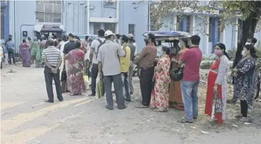  ??  ?? 0 People queue up to receive the the Covishield Covid-19 vaccine at a hospital in Siliguri