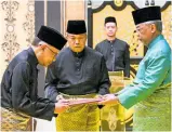  ?? ?? King Sultan Abdullah Sultan Ahmad Shah (right) and new Prime Minister Anwar Ibrahim (left) at the swearing-in ceremony at the National Palace, Kuala Lumpur. Photo / AP