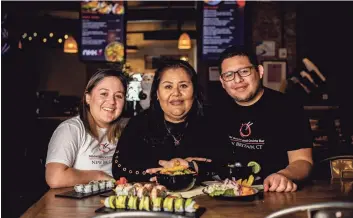  ?? Lisa Nichols / For Hearst Connecticu­t Media ?? Fanny Puertas, center, with her daughter Africa Vargas and her son Nikko Vargas, owners of Nikko Sushi and Ceviche Bar at The Assembly Room in New Britain.