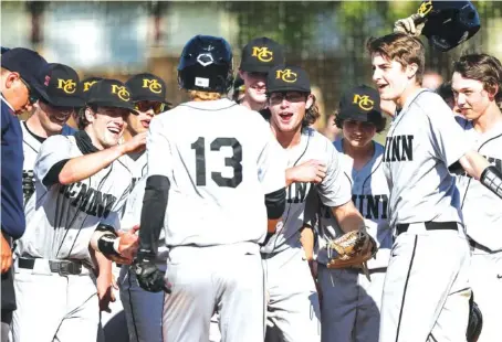  ?? STAFF PHOTOS BY TROY STOLT ?? McMinn County’s Jace Hyde (13) is met by his teammates at home plate after hitting a home run during Monday’s game against East Hamilton in Ooltewah. McMinn County won 10-2.