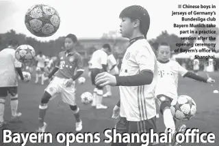  ?? AFP PHOTO ?? Chinese boys in jerseys of Germany’s Bundesliga club Bayern Munich take part in a practice session after the opening ceremony of Bayern’s office in Shanghai.