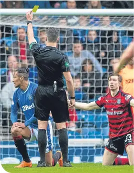  ??  ?? Bruno Alves escapes with a yellow for a tackle on Craig Wighton