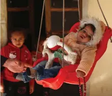  ?? AFP ?? Afraa sits in a swing at her uncle’s house where she lives in Jandaris, north-west of Aleppo province