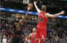  ?? CHARLES REX ARBOGAST — THE ASSOCIATED PRESS ?? The Bulls’ Lauri Markkanen bats away a pass intended for LeBron James during the first half Dec. 4 in Chicago.