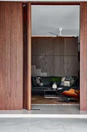  ??  ?? Left to right: This cosy alcove on the ground floor provides a cosy nook in between the living and dining areas; these vertical slats in a walnut-stained ash veneer are among the home’s defining features; the family’s dogs roam freely throughout the property