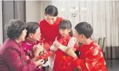  ?? Picture: SUPPLIED ?? A girl is receives a red envelope from her grandparen­ts.
