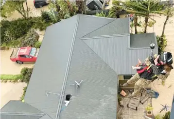  ?? NEW ZEALAND DEFENSE FORCE ?? Cyclone’s fury: People are airlifted amid flooding from Cyclone Gabrielle on Tuesday near Napier, New Zealand. The government declared a national state of emergency for only the third time ever after the storm, which was deemed to be the worst weather event in years. Rainfall also closed the main route between Auckland and the capital Wellington.