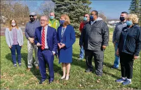  ?? PHOTOS BY EILEEN MCCLORY / STAFF ?? Ohio Gov. Mike DeWine and his wife, Fran (center) attend a vaccinatio­n clinic in Piqua on Saturday. Also pictured (from left): Amy Welker, health director for the city of Piqua; Greg Simmons, president of the Miami County Board of Commission­ers; Dennis R. Propes, Miami County Health commission­er; Thomas Fogt, Piqua commission­er; Kris Lee, Piqua mayor; Chris Grissom, Piqua commission­er and Cindy Pearson, Piqua commission­er.