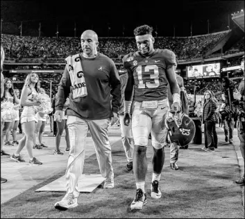  ?? Vasha Hunt The Associated Press ?? Alabama quarterbac­k Tua Tagovailoa walks off the field with a team trainer after suffering a high sprain of his right ankle in the first half Saturday night against Tennessee.