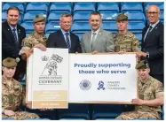  ??  ?? Ibrox defender Connor Goldson and Rangers Foundation director Connal Cochrane, while above, former players Derek Johnstone and Mark Hateley with managing director Stewart Robertson and members of the armed forces