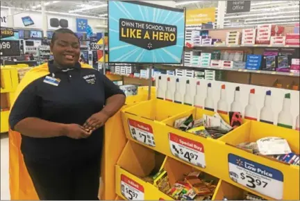  ?? GARY PULEO — DIGITAL FIRST MEDIA ?? Wearing her yellow cape, West Norriton Walmart associate Chardanay White is one of several Walmart associates ready to assist customers as a Back-to-School Helper.