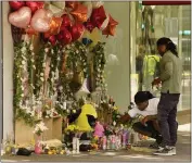  ?? ?? Mourners visit a memorial to victims of a recent mass shooting in Sacramento Friday.