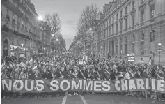  ?? DAN KITWOOD, GETTY IMAGES ?? Demonstrat­ors make their way along Place de la République Jan. 11, 2015, following the Charlie Hebdo attack in Paris.