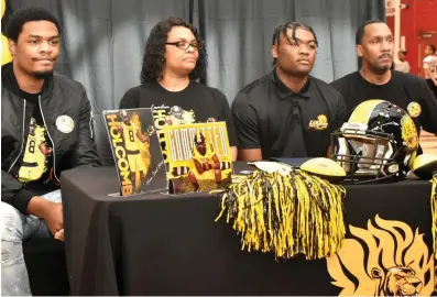  ?? (Pine Bluff Commercial/I.C. Murrell) ?? Landon Holcomb (second from right) of Pine Bluff High School signed with the University of Arkansas at Pine Bluff.