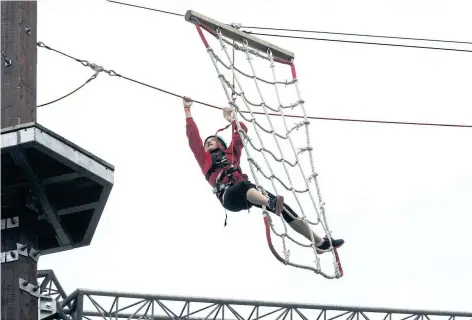  ?? JULIE JOCSAK/POSTMEDIA NEWS ?? Samantha Martin, 14, of Niagara Falls, makes her way through an aerial obstacle course at the new WildPlay in Niagara Falls. WildPlay's Whirlpool Adventure Course was officially opened on Friday.