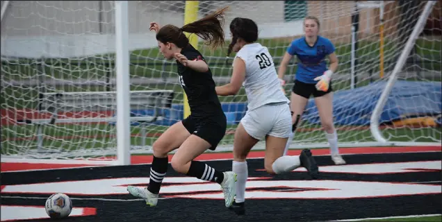  ?? ?? Special to McDonalD
county preSS
McDonald County sophomore Anna
Clarkson (left) is knocked off the ball by neosho’s lorlei pelep in front of the goal tuesday night. neosho won the game, 4-3, in double overtime.