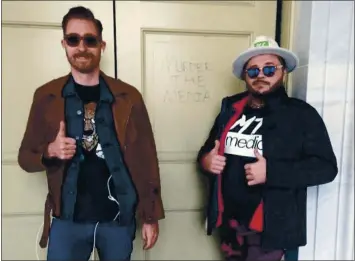  ?? DEPARTMENT OF JUSTICE VIA THE NEW YORK TIMES ?? Nicholas Ochs, left, and Nicholas Decarlo pose in front of graffiti at the U.S. Capitol in Washington on Jan. 6.