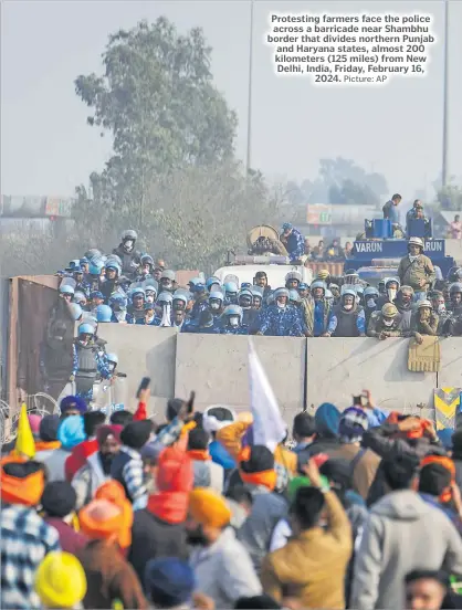  ?? Picture: AP ?? Protesting farmers face the police across a barricade near Shambhu border that divides northern Punjab and Haryana states, almost 200 kilometers (125 miles) from New Delhi, India, Friday, February 16, 2024.