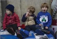  ??  ?? Jack Keane, Michael Keane and James Keane, trying to keep their attention at the Calf Health and Rearing open day.