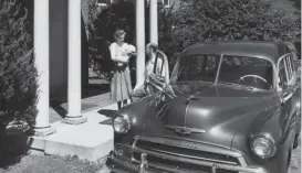  ??  ?? A mother holds a baby outside Lake Forest Hospital in the 1950s, a time before “bourgeois values” began their decline.