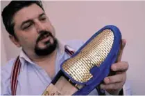  ??  ?? Antonio Vietri shows a men’s shoe as part of his collection ‘Gold’.