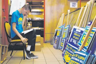  ?? Photos by Lea Suzuki / The Chronicle ?? Anubis Daugherty, who has been homeless for much of his life, works the phones for the Yes on C campaign Monday. Daugherty is now housed in a single-room place of his own, thanks to anti-homeless programs.