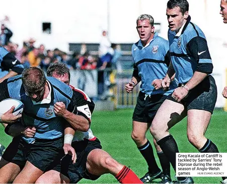  ?? HUW EVANS AGENCY ?? Greg Kacala of Cardiff is tackled by Sarries’ Tony Diprose during the rebel season of Anglo-Welsh games