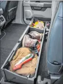  ??  ?? The available lockable, fold-flat, dividable storage extends the width of the interior under the rear seats and allows for safe storage of valuables. Great for long items like hunting gear, fishing rods or blueprints.