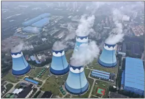  ?? (AP/Chinatopix) ?? In this September 2021 file photo, steam billows out of the cooling towers at a coal-fired power station in Nanjing in eastern China’s Jiangsu province.