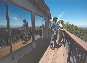  ?? PATRICK TEHAN - STAFF PHOTOGRAPH­ER ?? Brian Malone, left, and Steve Abbors, of the Midpeninsu­la Regional Open Space District, check out the view from the district’s cabin located in the hills above Los Gatos.