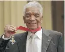  ?? ANTHONY DEVLIN/PA VIA AP ?? Earl Cameron in 2009, after being presented his medallion as Commander of the Most Excellent Order of the British Empire.