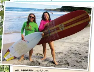  ??  ?? ALL A-BOARD: Lucy, right, and surf instructor Jane get ready to ride the waves