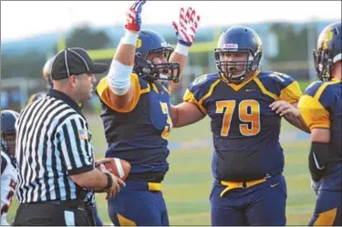  ?? SAM STEWART - DIGITAL FIRST MEDIA ?? Upper Perkiomen’s Austin Tutolo raises his arms toward the referee, hoping for a touchdown signal after his one-yard plunge. The referee obliged, prompting a celebratio­n from the running back.
