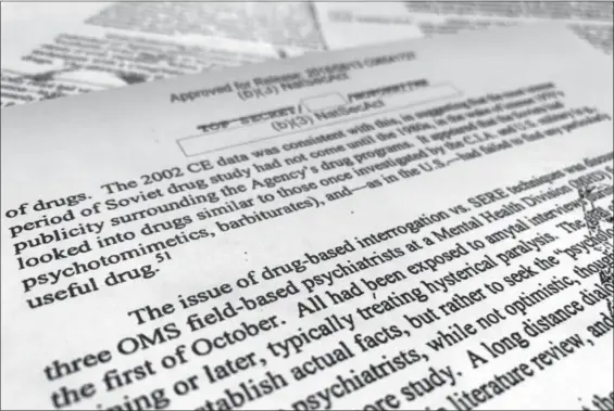  ?? JON ELSWICK — THE ASSOCIATED PRESS ?? A portion of a once-classified CIA report that disclosed the existence of a drug research program dubbed “Project Medication” is photograph­ed in Washington, Tuesday. Shortly after 9/11, the CIA considered using a drug that might work like a truth serum and force terror suspects to give up informatio­n about potential attacks. After months of research, the agency decided that a drug called Versed, a sedative often prescribed to reduce anxiety, was “possibly worth a try.” But in the end, the CIA decided not to ask government lawyers to approve its use. The American Civil Liberties Union fought in court to have the report released.