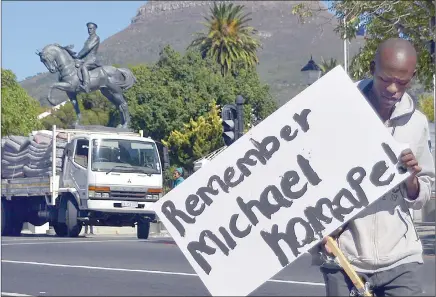  ?? PICTURE: ARMAND HOUGH ?? REMEMBER HIM: Sinekhaya Mbengo walks away from the protest with a board showing support for a pupil who died in the Eastern Cape. Pupils and supporters of Equal Education staged a sleep-in front of Parliament to protest against inequality in the...