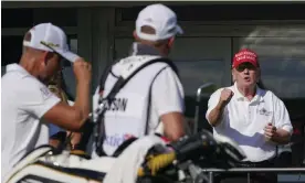 ?? Photograph: Seth Wenig/AP ?? Donald Trump gestures toward Henrik Stenson after the second-round leader played the 16th hole.