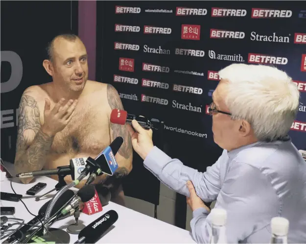  ??  ?? 0 Mark Williams is as good as his word as he conducts his press conference in the nude after his 18-16 win over John Higgins in the World Snooker Championsh­ip final.