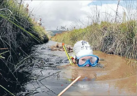  ?? Photo: REUTERS ?? Dirty work: One of the bog snorkellin­g hopefuls in the world championsh­ips in Wales.