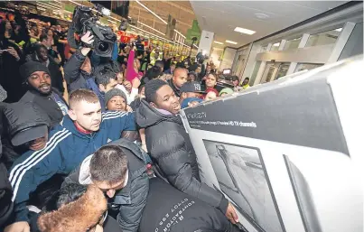  ?? Picture: PA. ?? Shoppers fight for bargains on Black Friday.