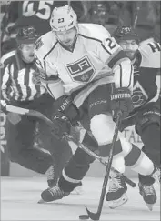  ?? David Zalubowski Associated Press ?? DUSTIN BROWN of the Kings drives down the ice with the puck ahead of Colorado’s Fedor Tyutin.