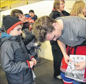  ?? ERIC MCCARTHY/JOURNAL PIONEER ?? A young fan waits patiently for an autograph from hometown favourite TJ Shea following the Summerside D. Alex MacDonald Ford Western Capitals’ home game against the Truro Bearcats in Tignish on Saturday night.