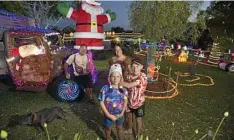  ?? Photo: Kevin Farmer ?? BRIGHT LIGHTS: Lucinda and Dean Paynter with their sons Will (left) and Lucas in their Gowrie Lilyvale Rd entry of The Chronicle Christmas Lights 2017 Competitio­n.