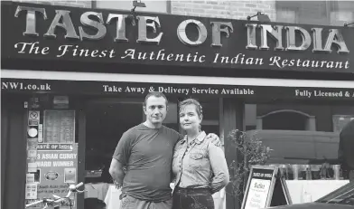  ?? MATT DUNHAM / THE ASSOCIATED PRESS ?? Polish couple Pawel Bednarek, a builder, and Aga Pozniak, who teaches training courses for adults, work part-time at the Taste of India curry restaurant in London. “I had never been in an Indian restaurant,” Pozniak says.