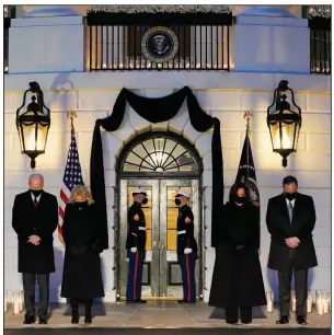  ?? (AP/Evan Vucci) ?? President Joe Biden (from left), first lady Jill Biden, Vice President Kamala Harris and husband Doug Emhoff bow their heads Monday outside the White House during a ceremony in memory of the more than 500,000 Americans who have died from covid-19.