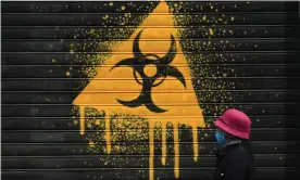  ?? Photograph: Paolo Salmoirago/ ?? The shutters of a shop emblazoned with a biohazard symbol, in Milan, Italy, in April ... ‘There are still many questions about the origins of Covid-19.’